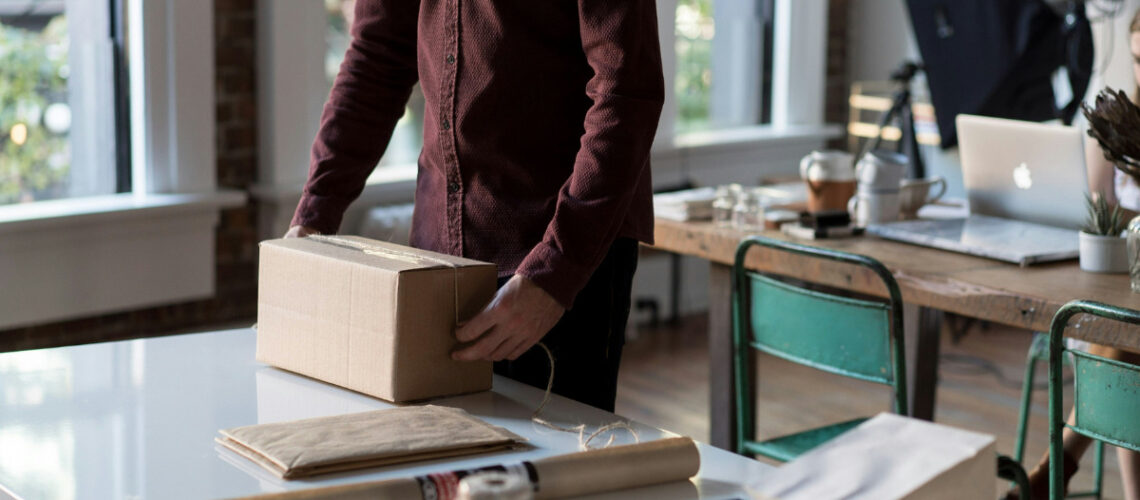 a person wrapping up a package