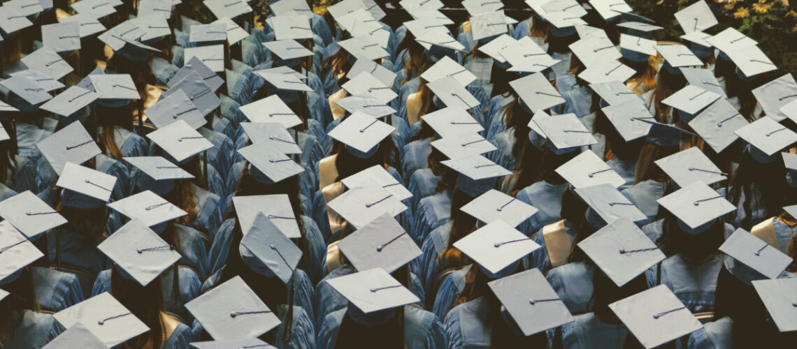 many students sitting at their graduation
