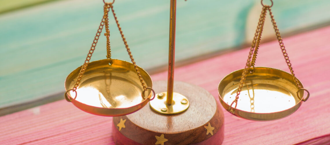 a gold weighing scale on a desk