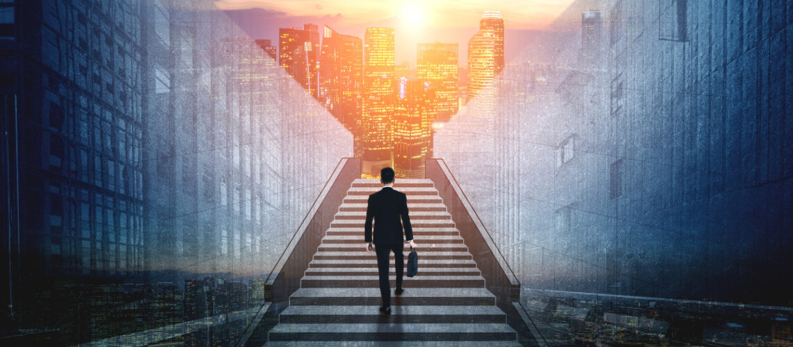 Businessman walking up a set of city stairs.