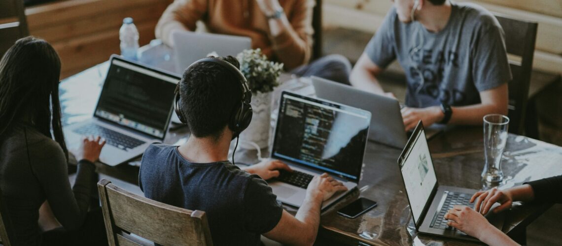 group of people using laptop computer