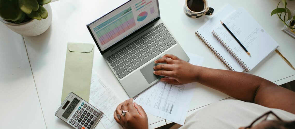 a person sitting at a table with a laptop