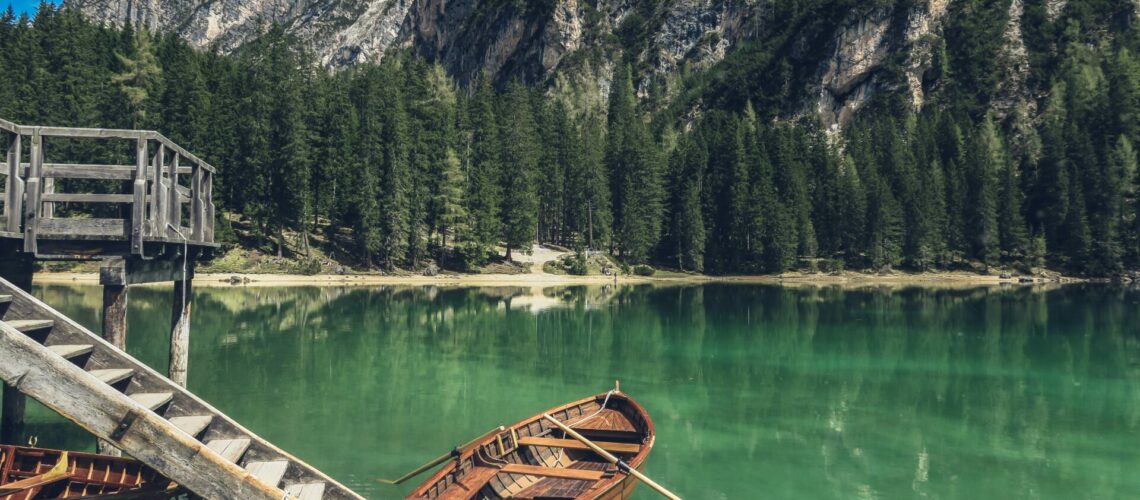 brown canoe docking on gray wooden staircaes